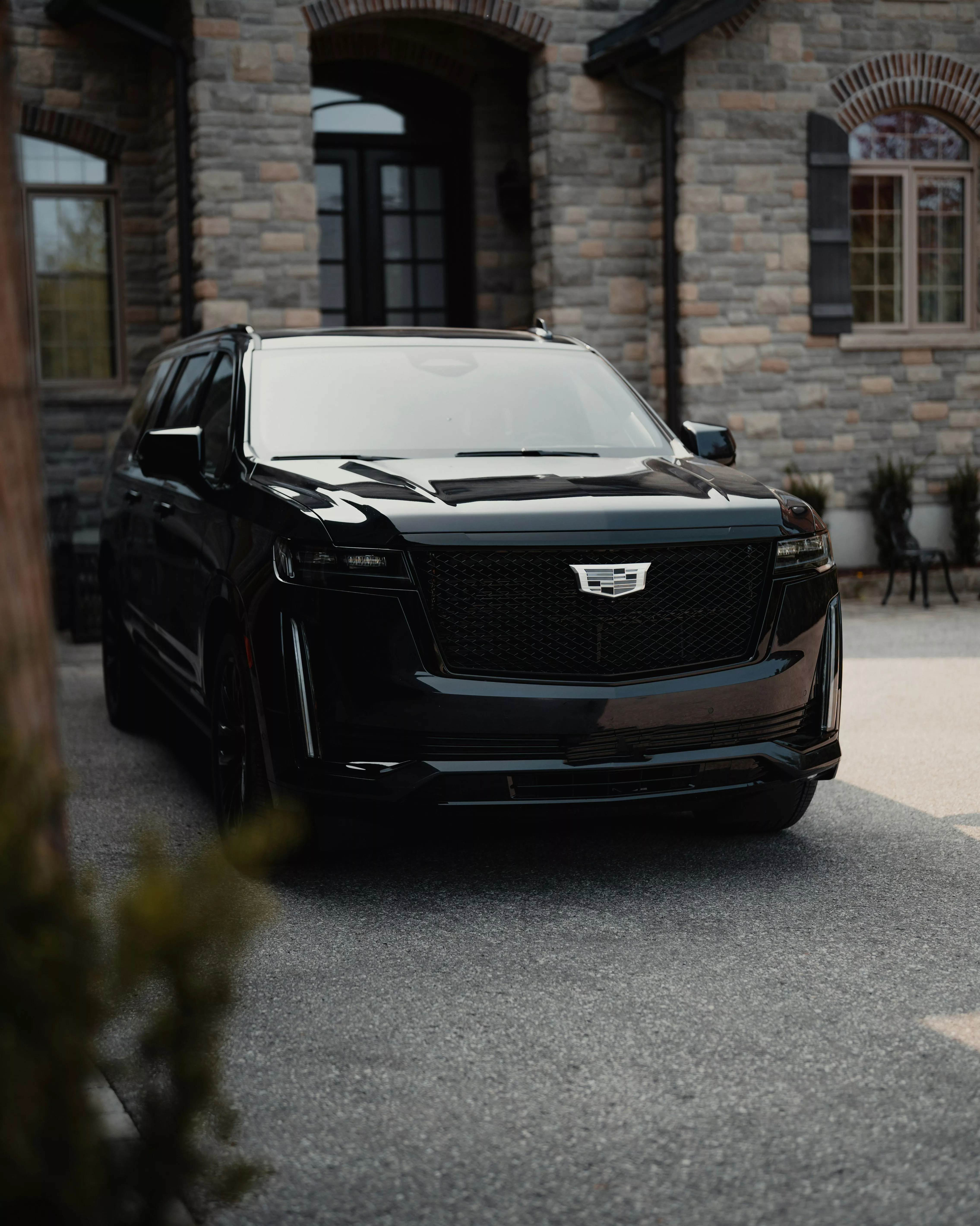 Cadillac Escalade IQ arriving at a luxury estate in Kansas City for Ghost Carriage chauffeur service