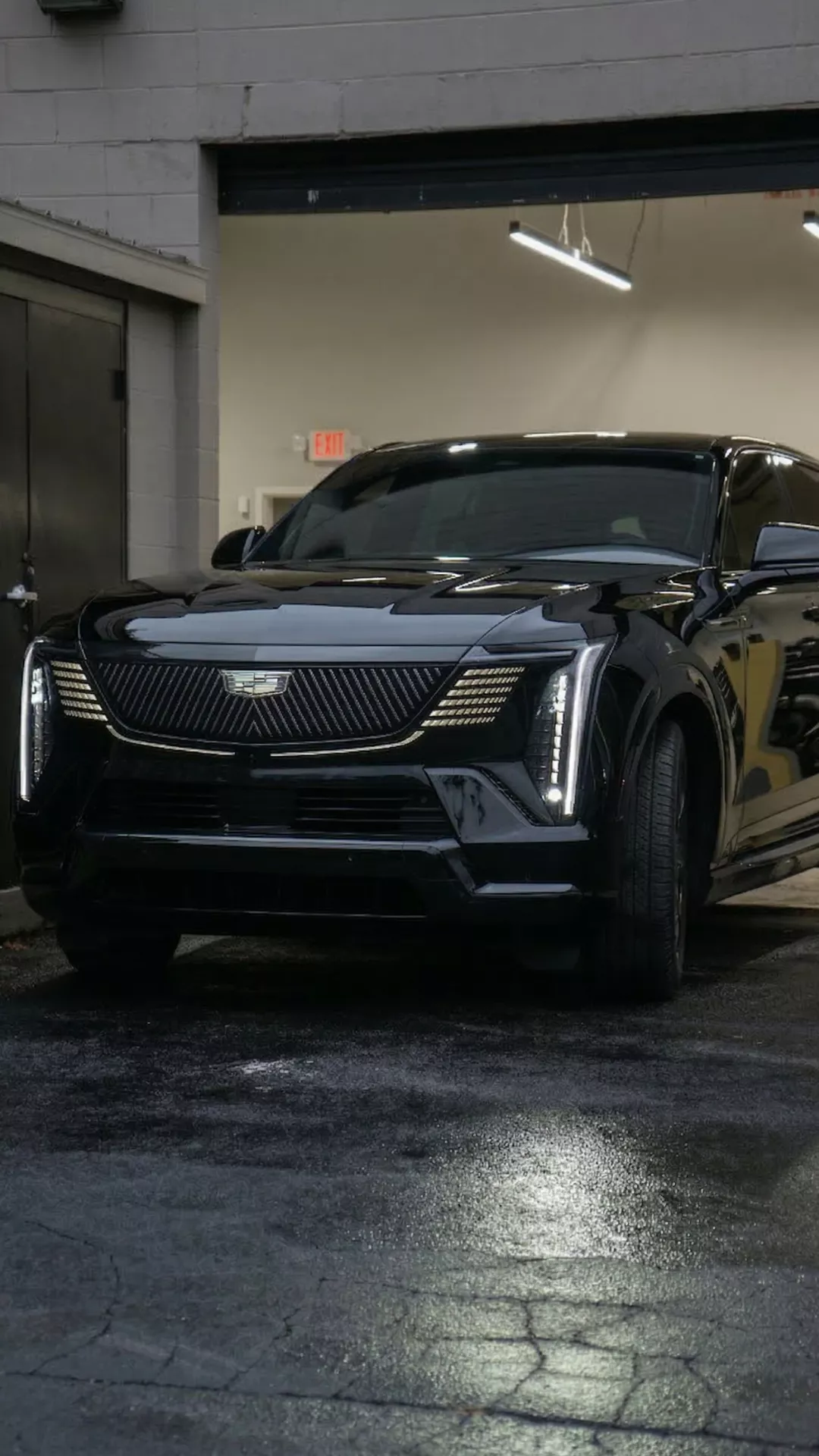 Cadillac Escalade IQ exiting a garage at night for Ghost Carriage in Kansas City